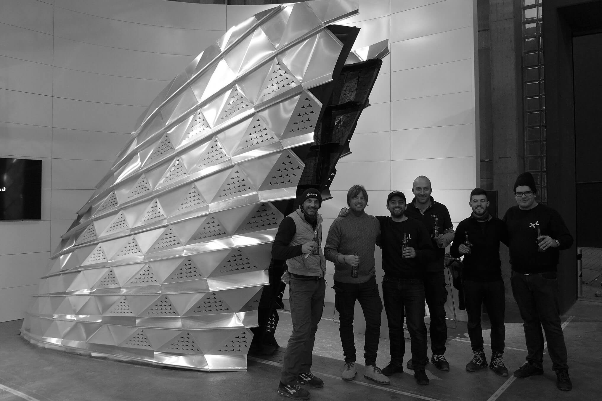 Design and construction team next to the completed SQUALO installation at Bolzano's faire